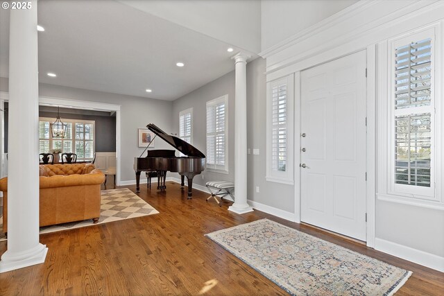 foyer with wood-type flooring and ornate columns