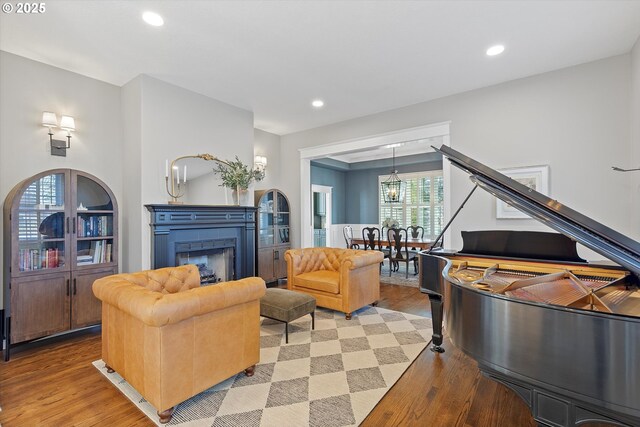 14218 NW Dunbar Ln, Portland, OR 97231 - living area featuring light wood-style flooring, recessed lighting, a fireplace, and a chandelier