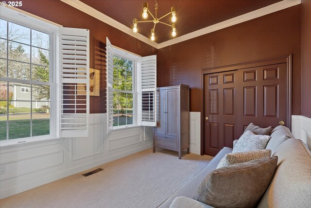 14218 NW Dunbar Ln, Portland, OR 97231 - living area with a chandelier, carpet, a wainscoted wall, a decorative wall, and ornamental molding