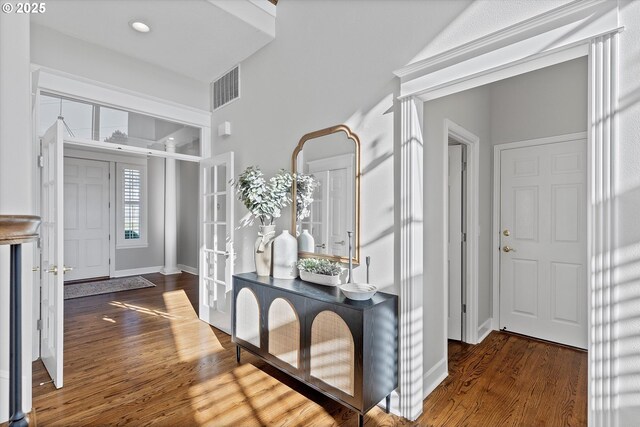 entrance foyer featuring dark hardwood / wood-style floors and french doors