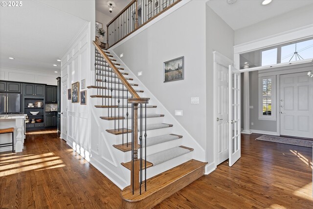 14218 NW Dunbar Ln, Portland, OR 97231 - foyer entrance with stairs, dark wood-style floors, recessed lighting, baseboards, and a high ceiling