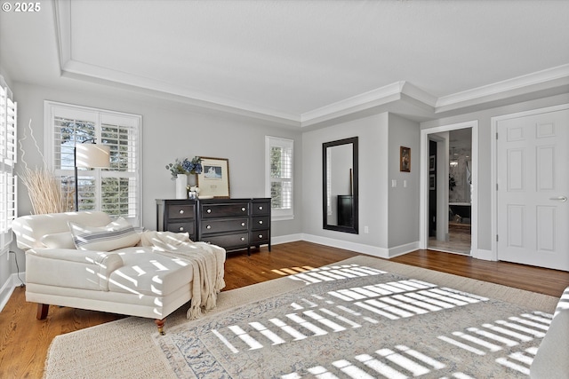 sitting room with ornamental molding, hardwood / wood-style floors, a fireplace, and a tray ceiling