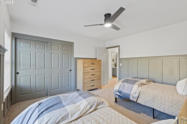 carpeted bedroom featuring multiple windows and ceiling fan