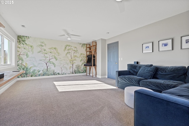 living room with light colored carpet, ceiling fan, visible vents, and baseboards