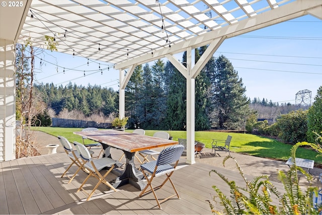 wooden deck with a fire pit, a lawn, and a pergola