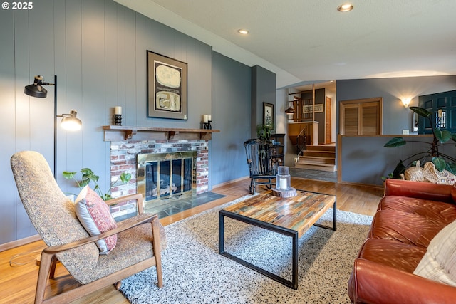 8836 SW 56th Ave, Portland, OR 97219 - living room with wood finished floors, a fireplace, recessed lighting, baseboards, and stairway