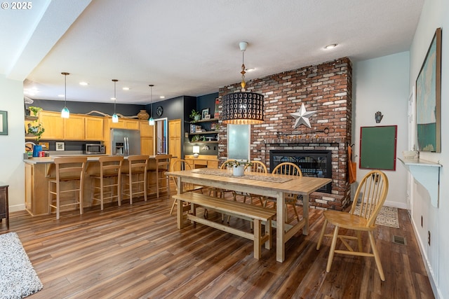 8836 SW 56th Ave, Portland, OR 97219 - dining room featuring wood finished floors, a fireplace, recessed lighting, baseboards, and a textured ceiling