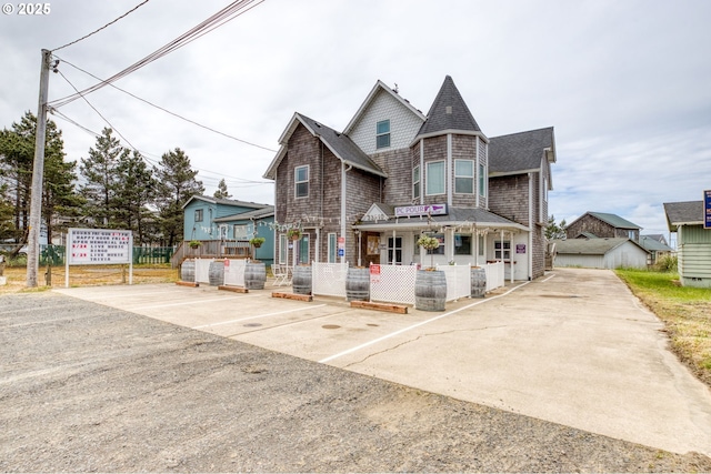 33310 Cape Kiwanda Dr, Pacific City, OR 97135 - view of front of house featuring a porch and a shingled roof