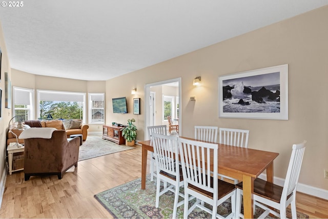 33310 Cape Kiwanda Dr, Pacific City, OR 97135 - dining space with light wood-type flooring, plenty of natural light, and baseboards