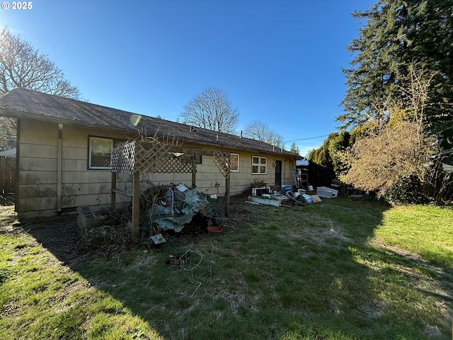 rear view of property featuring a yard