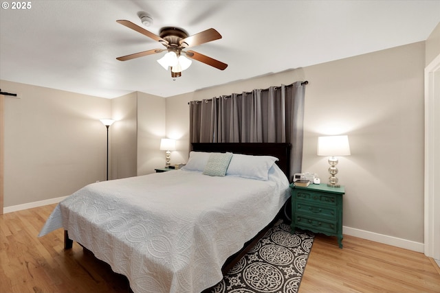 bedroom featuring light hardwood / wood-style floors and ceiling fan