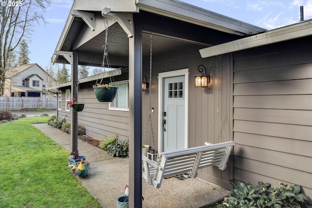 doorway to property with a lawn