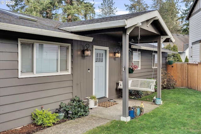 view of exterior entry featuring a lawn