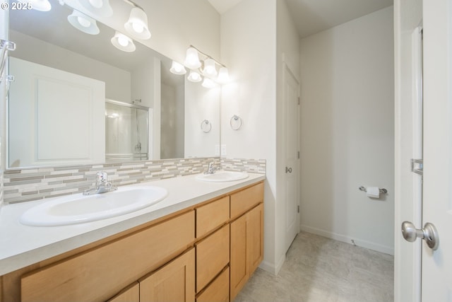 bathroom featuring tasteful backsplash, vanity, and a shower with door