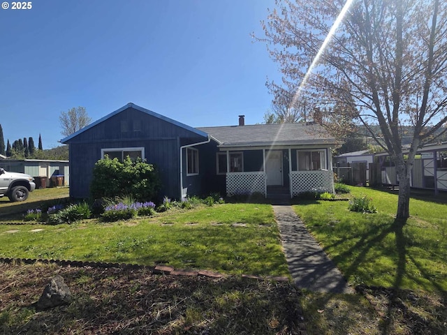 view of front of property featuring a chimney, entry steps, and a front lawn