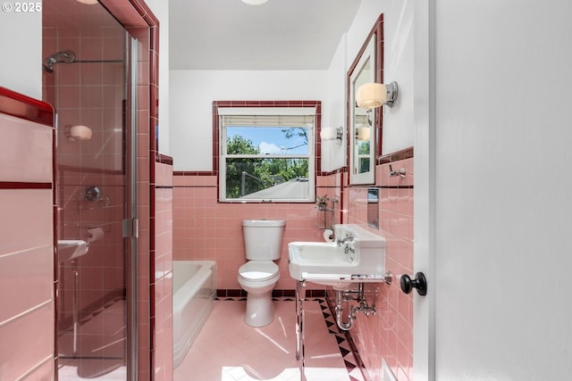 2153 SE 20th Ave, Portland, OR 97214 - bathroom with tile walls, toilet, tile patterned floors, an enclosed shower, and a sink