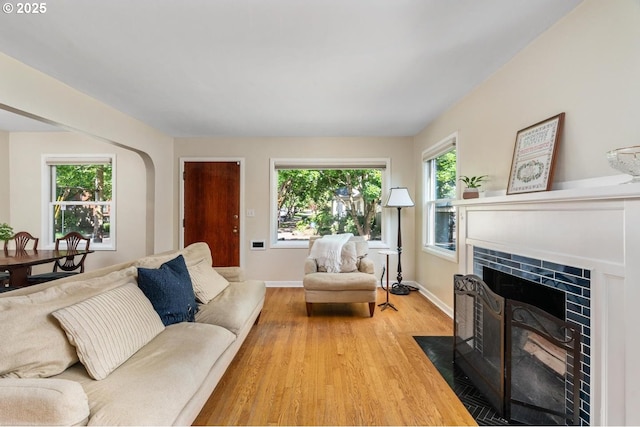 2153 SE 20th Ave, Portland, OR 97214 - living room with a fireplace, wood finished floors, and baseboards