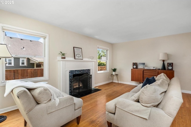 2153 SE 20th Ave, Portland, OR 97214 - living area with a fireplace with flush hearth, wood finished floors, and baseboards
