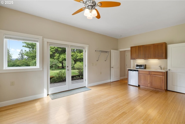 20905 NE 96th Ave, Battle Ground, WA 98604 - kitchen with dishwasher, brown cabinets, a sink, and baseboards