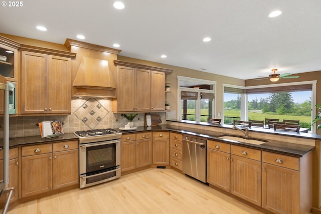 20905 NE 96th Ave, Battle Ground, WA 98604 - kitchen featuring appliances with stainless steel finishes, a sink, custom exhaust hood, light wood-style flooring, and open shelves
