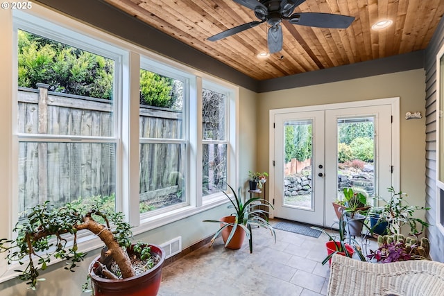 sunroom / solarium with wood ceiling, french doors, and ceiling fan