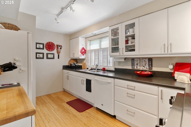 4825 SE 33rd Ave, Portland, OR 97202 - kitchen with dishwasher, light wood-style floors, white cabinets, and dark countertops