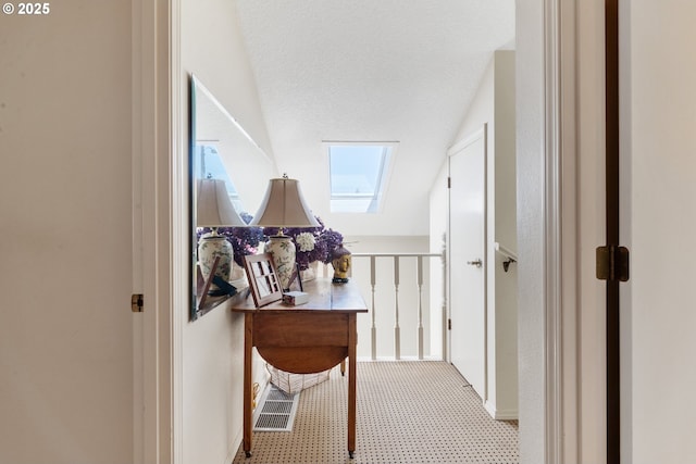 4825 SE 33rd Ave, Portland, OR 97202 - corridor featuring carpet flooring, vaulted ceiling, a desk, and a skylight