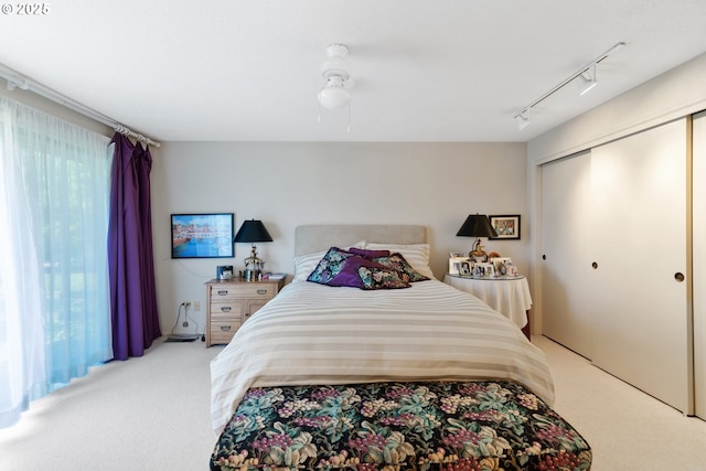 4825 SE 33rd Ave, Portland, OR 97202 - bedroom with light carpet, rail lighting, a closet, and a ceiling fan