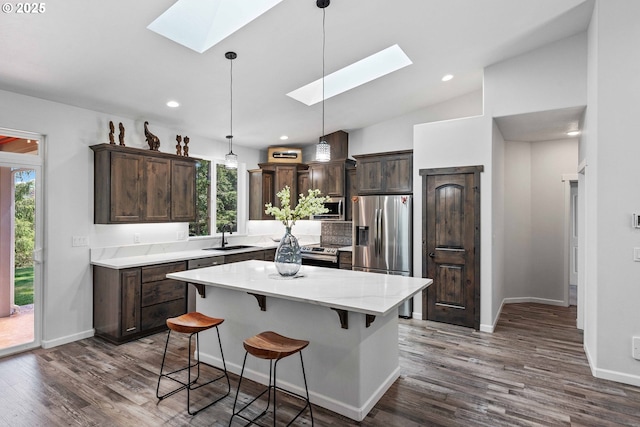 69857 Stage Rd, North Bend, OR 97459 - kitchen featuring a skylight, stainless steel appliances, a sink, dark brown cabinets, and plenty of natural light