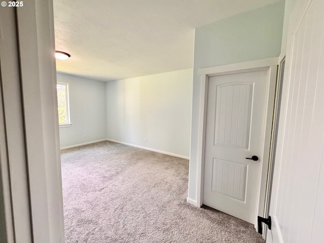 69857 Stage Rd, North Bend, OR 97459 - carpeted spare room with baseboards and a textured ceiling