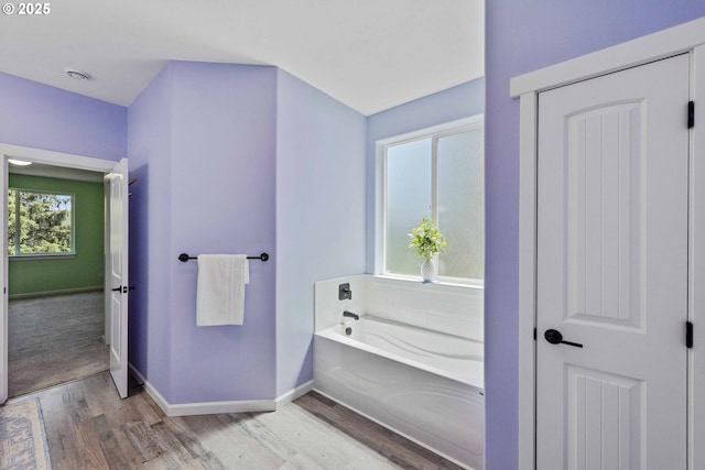 69857 Stage Rd, North Bend, OR 97459 - bathroom featuring wood finished floors, a garden tub, and baseboards
