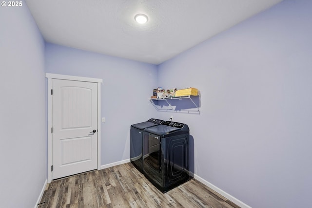 69857 Stage Rd, North Bend, OR 97459 - laundry room featuring washer and dryer, wood finished floors, and baseboards