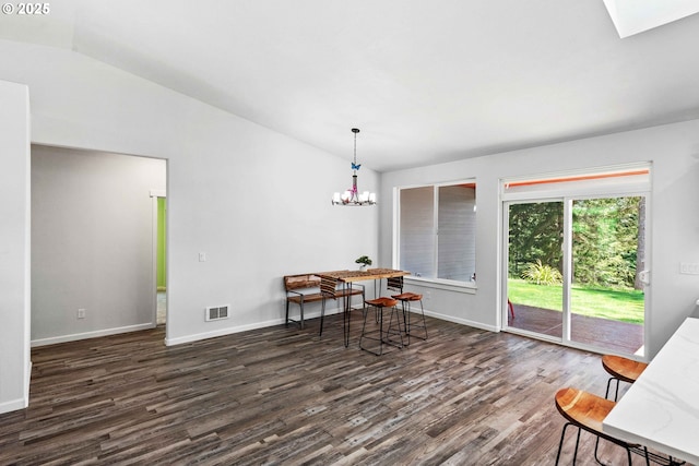 69857 Stage Rd, North Bend, OR 97459 - dining space with wood finished floors, lofted ceiling, baseboards, a chandelier, and a skylight