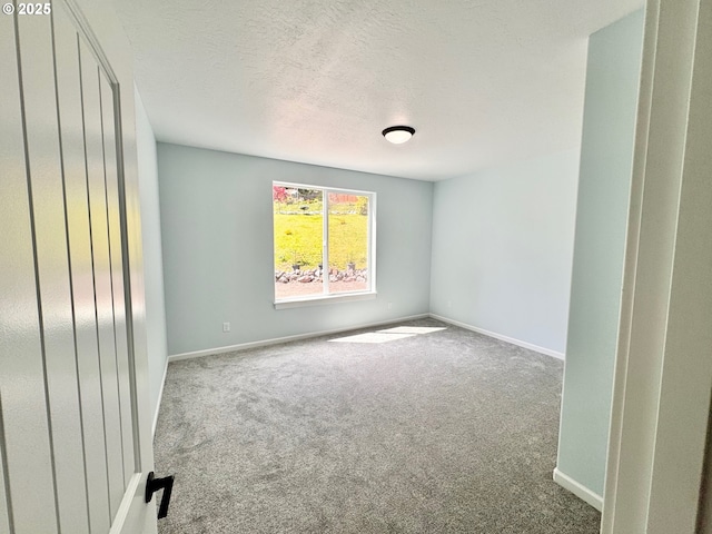 69857 Stage Rd, North Bend, OR 97459 - carpeted empty room featuring a textured ceiling and baseboards