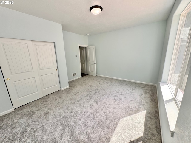 69857 Stage Rd, North Bend, OR 97459 - unfurnished bedroom featuring carpet floors, baseboards, and a closet