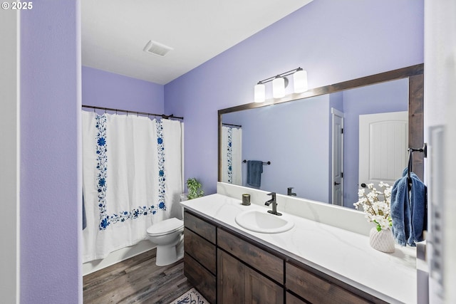 69857 Stage Rd, North Bend, OR 97459 - full bathroom with vanity, toilet, wood finished floors, and a shower with curtain