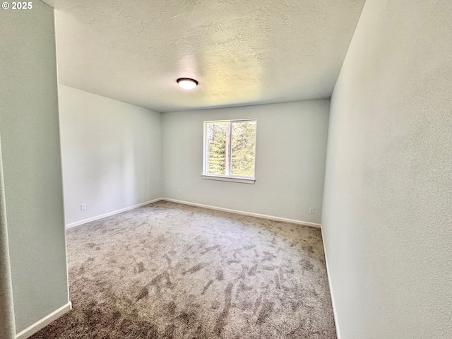 69857 Stage Rd, North Bend, OR 97459 - carpeted empty room with baseboards and a textured ceiling