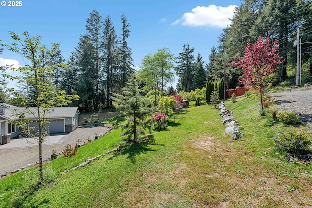 69857 Stage Rd, North Bend, OR 97459 - view of grassy yard featuring an attached garage and dirt driveway