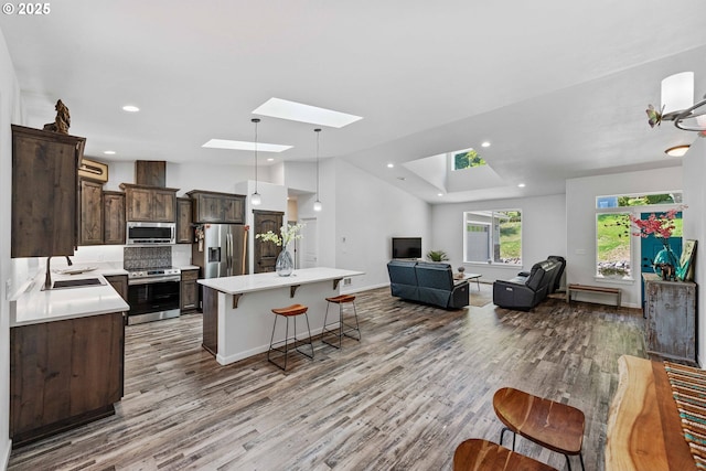 69857 Stage Rd, North Bend, OR 97459 - living area with a skylight, wood finished floors, baseboards, and recessed lighting