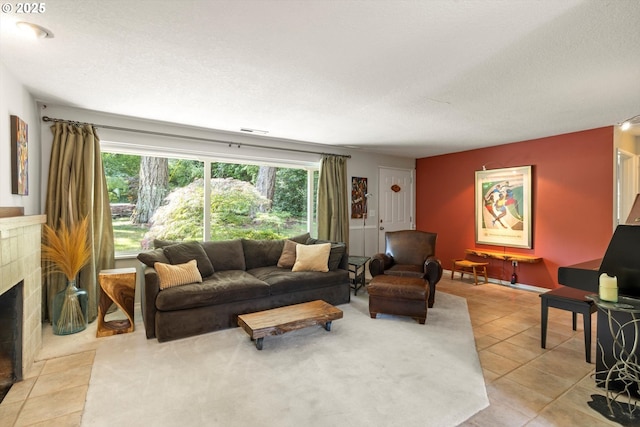 1725 Southshore Blvd, Lake Oswego, OR 97034 - living room featuring a fireplace, light tile patterned flooring, and a textured ceiling