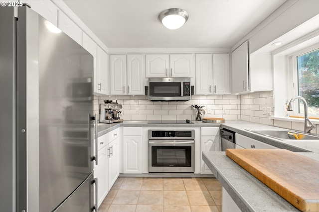 1725 Southshore Blvd, Lake Oswego, OR 97034 - kitchen with appliances with stainless steel finishes, white cabinetry, backsplash, and light tile patterned floors