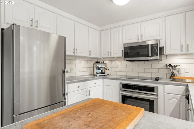 1725 Southshore Blvd, Lake Oswego, OR 97034 - kitchen with stainless steel appliances, white cabinetry, light countertops, and backsplash