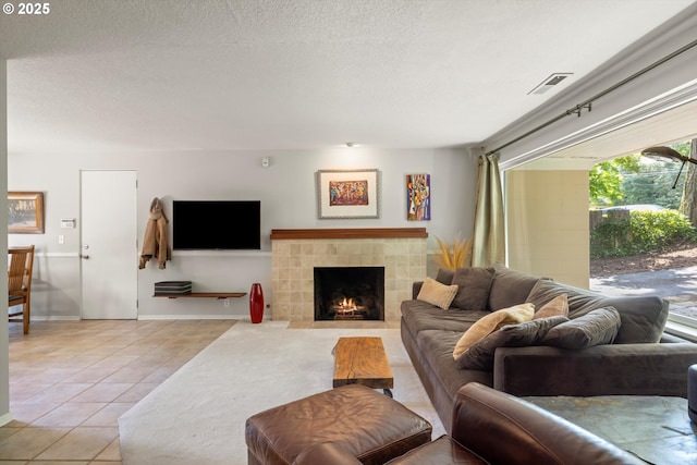 1725 Southshore Blvd, Lake Oswego, OR 97034 - living area featuring light tile patterned floors, a tiled fireplace, and a textured ceiling
