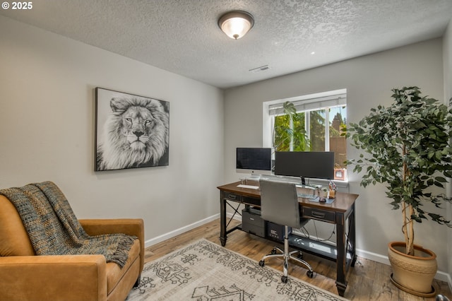 10840 SW Black Diamond Way, Portland, OR 97223 - office with baseboards, wood finished floors, and a textured ceiling