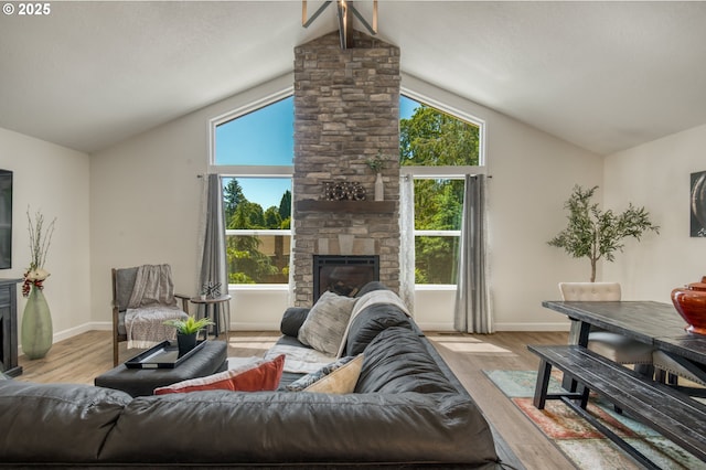 10840 SW Black Diamond Way, Portland, OR 97223 - living room with a fireplace, lofted ceiling, wood finished floors, and plenty of natural light