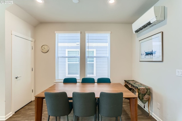 dining room featuring hardwood / wood-style flooring and a wall unit AC