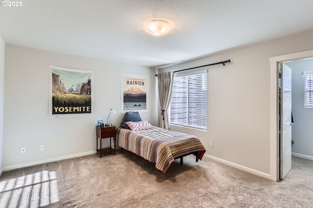 bedroom featuring light carpet and a textured ceiling