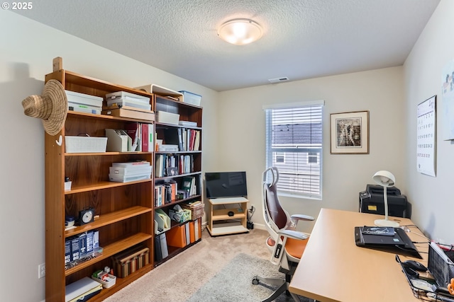 office space with light carpet and a textured ceiling