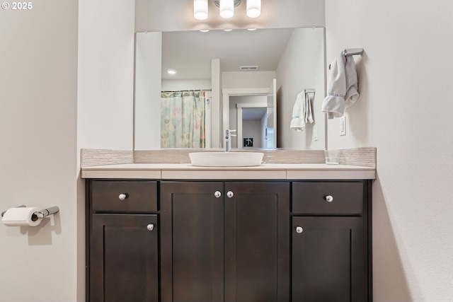 bathroom featuring vanity and a shower with curtain