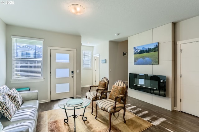 living room featuring dark hardwood / wood-style floors and a textured ceiling